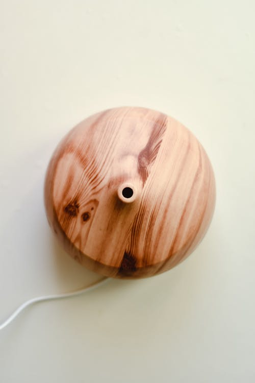 wooden diffuser with electric cord on a white surface