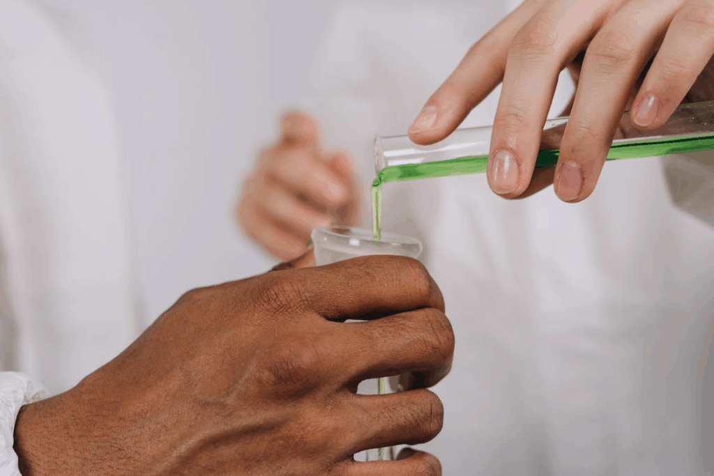 chemists pouring chemicals on a boiling mask