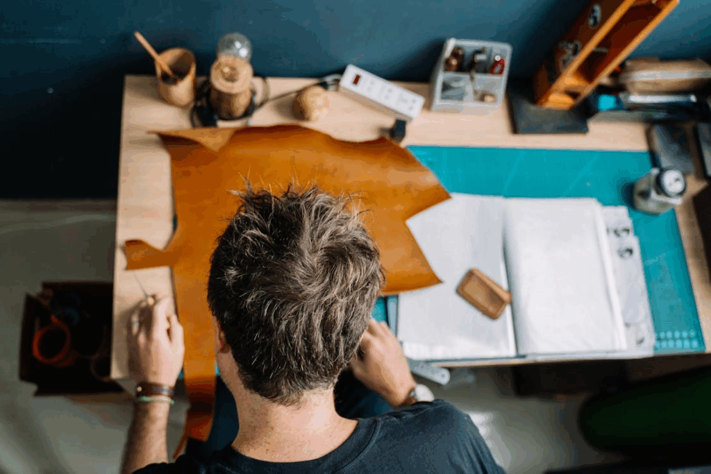 a man cutting leather
