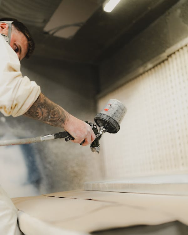 a professional working with waterborne polyurethane spray