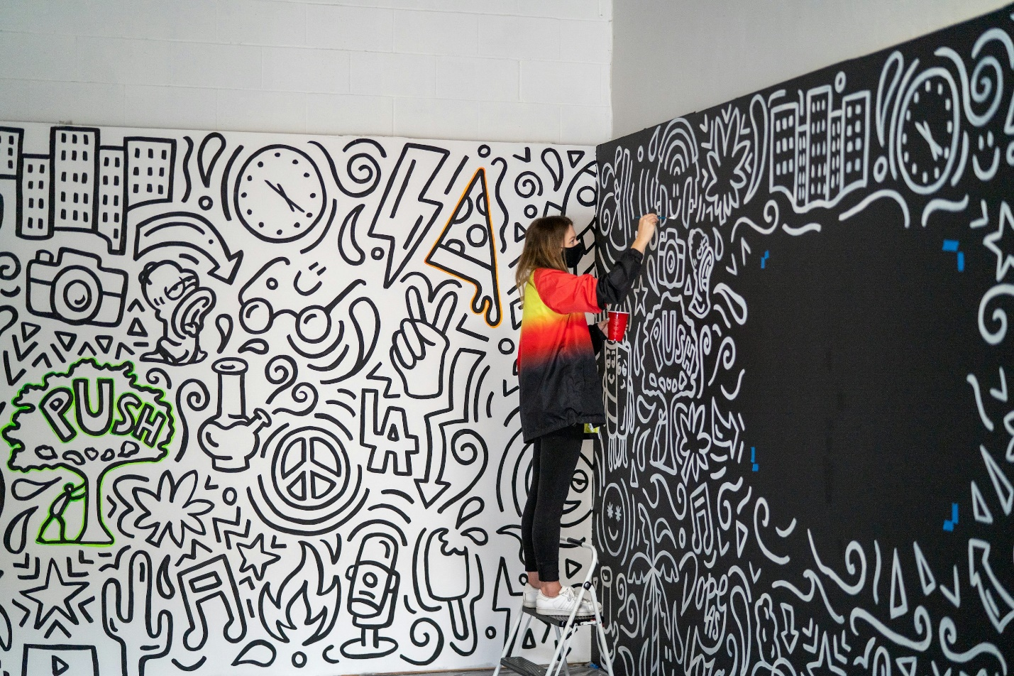 an artist working on a stunning mural