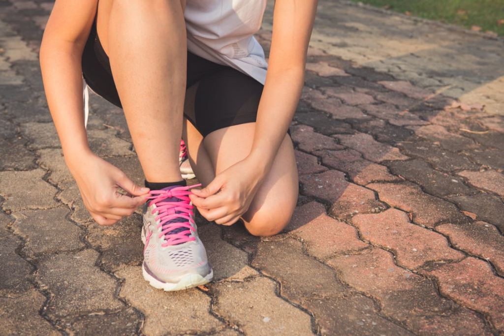 A woman tying her shoe