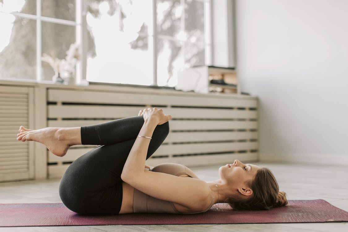 Woman doing yoga in performance wear
