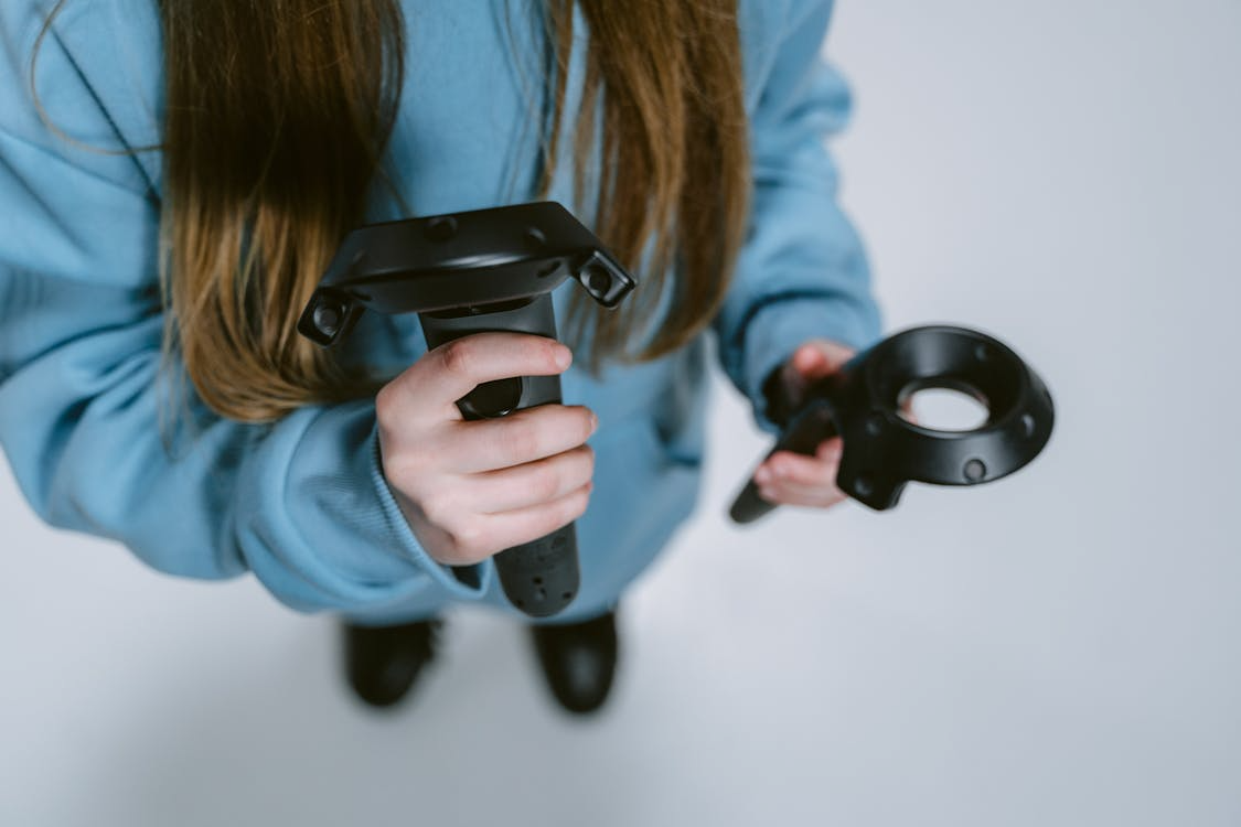 A person holding VR controllers