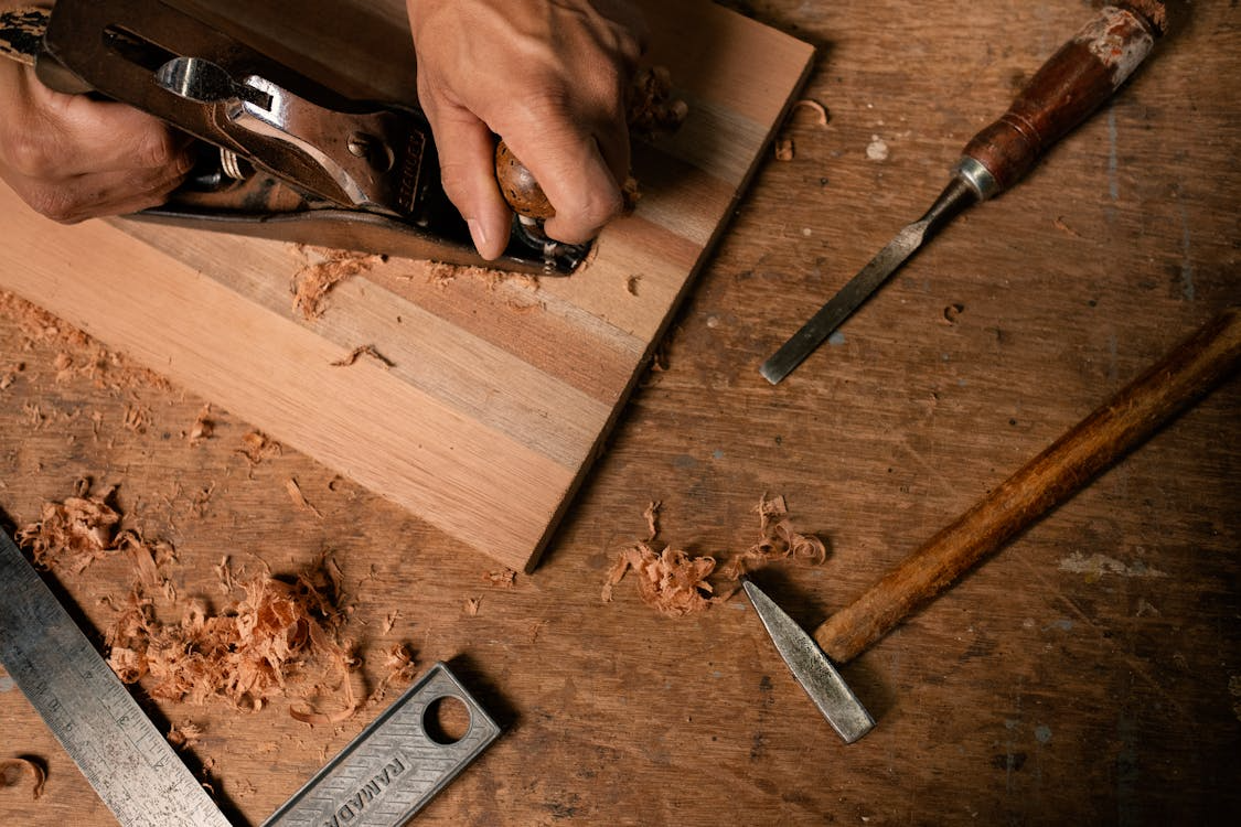 A person using a wood planer