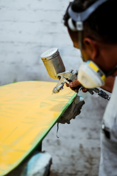 a person coating wood with WPUs