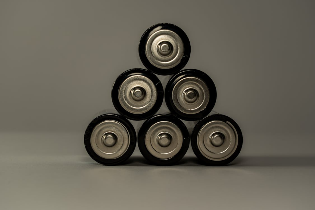 close-up of the top of batteries stacked together to form a triangle