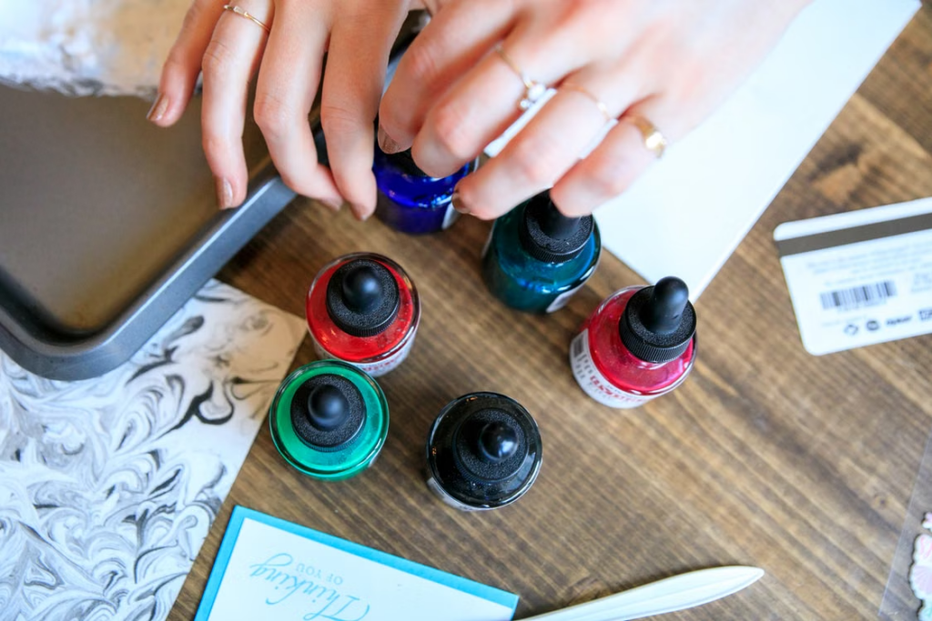 Image Alt Text: A person checking colorful ink bottles