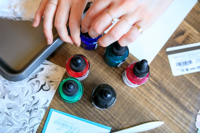 Image Alt Text: A person checking colorful ink bottles