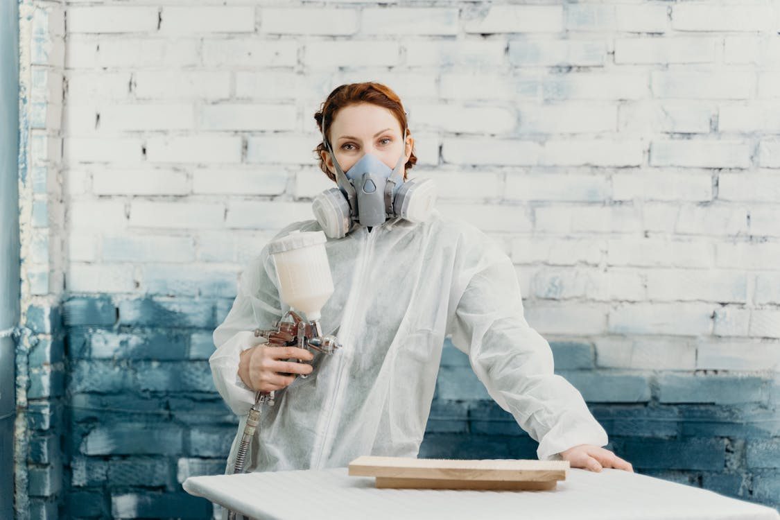 A woman coating wood with WPUs