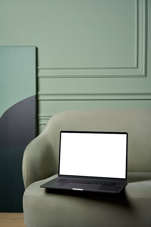 A laptop on an armchair