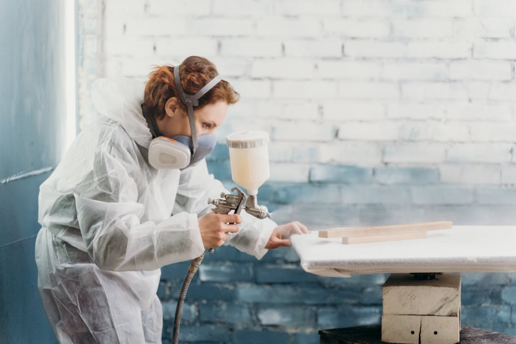 A person spraying wood with WPU dispersions