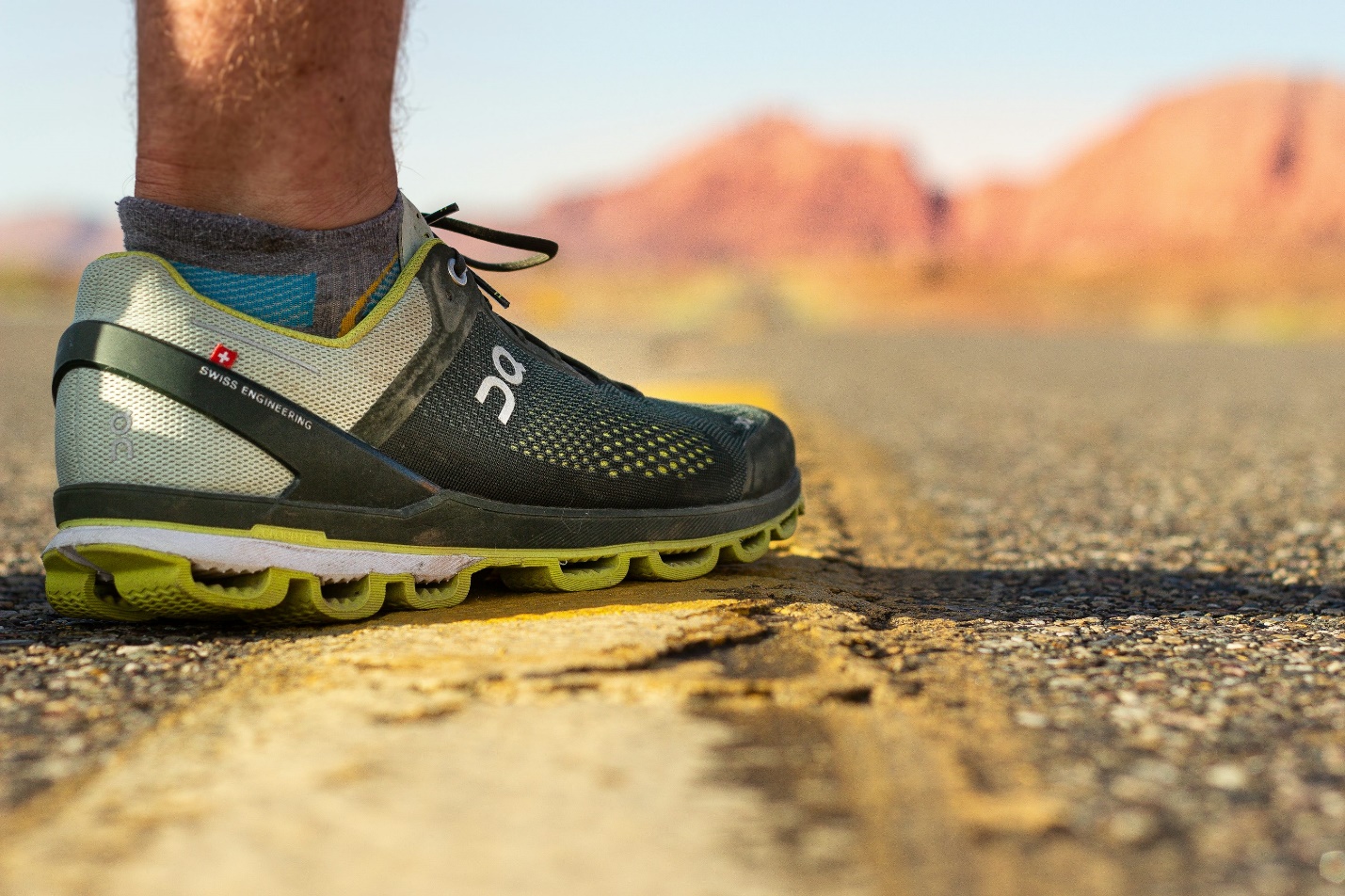 person wearing black and yellow nike running shoes